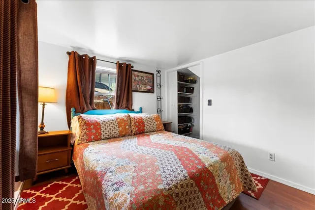 a bedroom with a bed and a closet