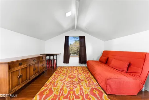 a balcony with couch and wooden floor