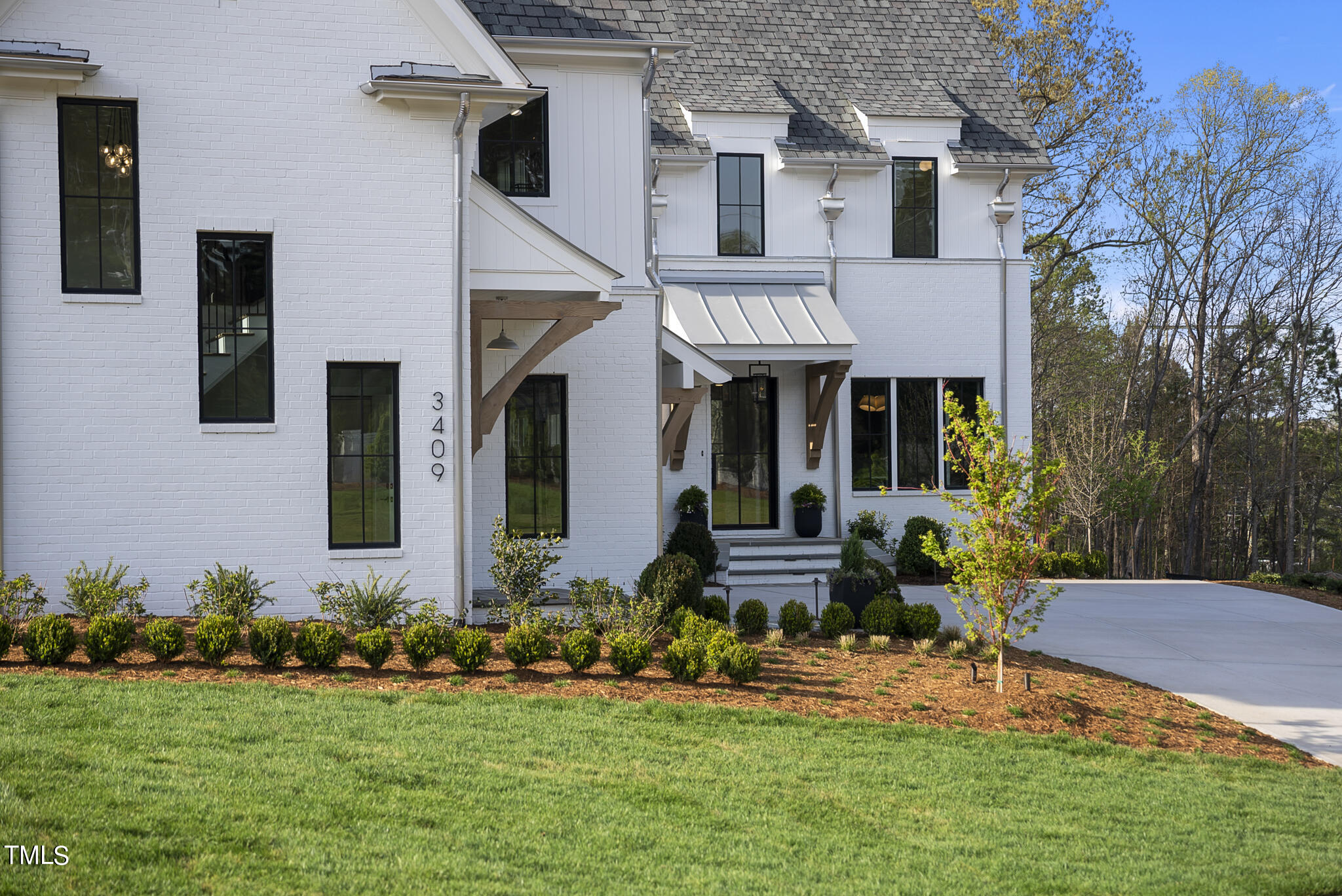 3409 Makers Circle Raleigh, NC 27612 - Photo 56 of 100 a front view of a house with a yard table and chairs