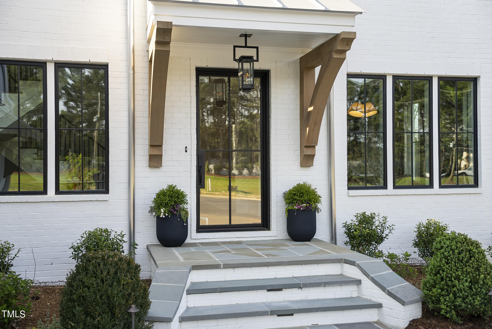 3409 Makers Circle Raleigh, NC 27612 - Photo 75 of 100 a view of a entryway door with flower pots