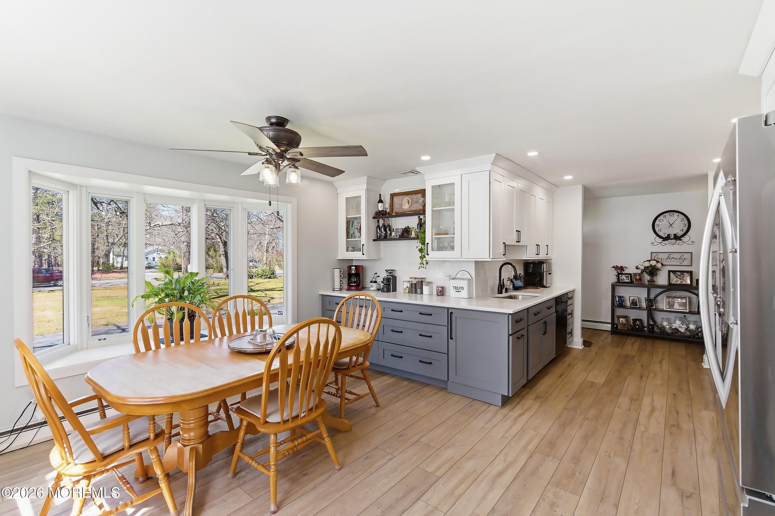 745 Oak Glen Road Howell, NJ 07731 - Photo 12 of 46 a kitchen with granite countertop a dining table chairs stainless steel appliances and cabinets