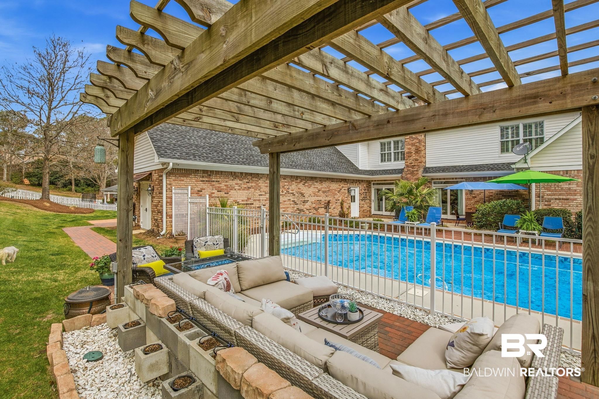 31515 Rhett Drive Spanish Fort, AL 36527 - Photo 79 of 100 Enjoy the evening sunsets with the fountain, outdoor seating area with fire pit. Pergola furniture & fire pit will convey with the home.