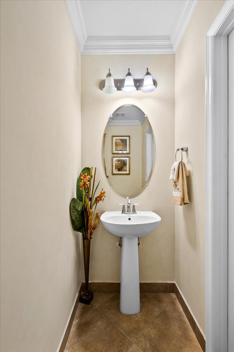 603 Dakota Drive Jupiter, FL 33458 - Photo 14 of 34 a bathroom with a sink toilet and a mirror