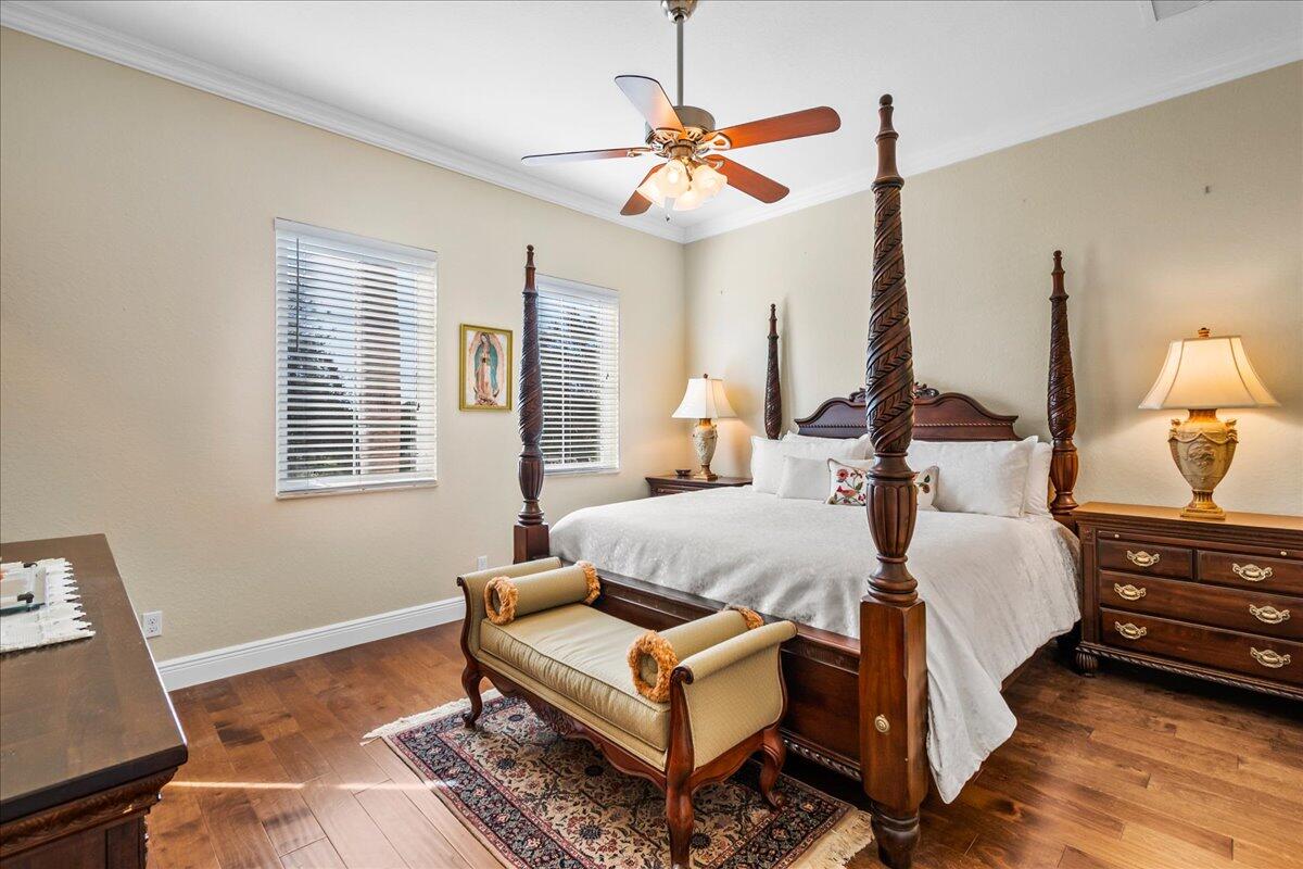 603 Dakota Drive Jupiter, FL 33458 - Photo 16 of 34 a bedroom with a bed and a chandelier