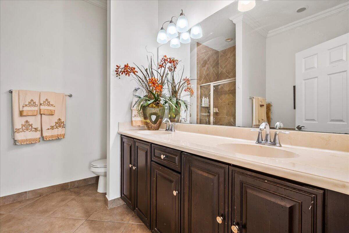603 Dakota Drive Jupiter, FL 33458 - Photo 17 of 34 a bathroom with a double vanity sink and a mirror