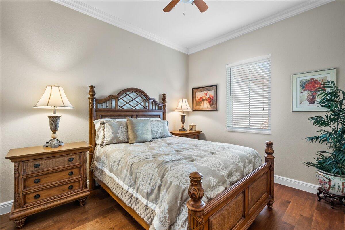 603 Dakota Drive Jupiter, FL 33458 - Photo 21 of 34 a bedroom with a bed and a potted plant