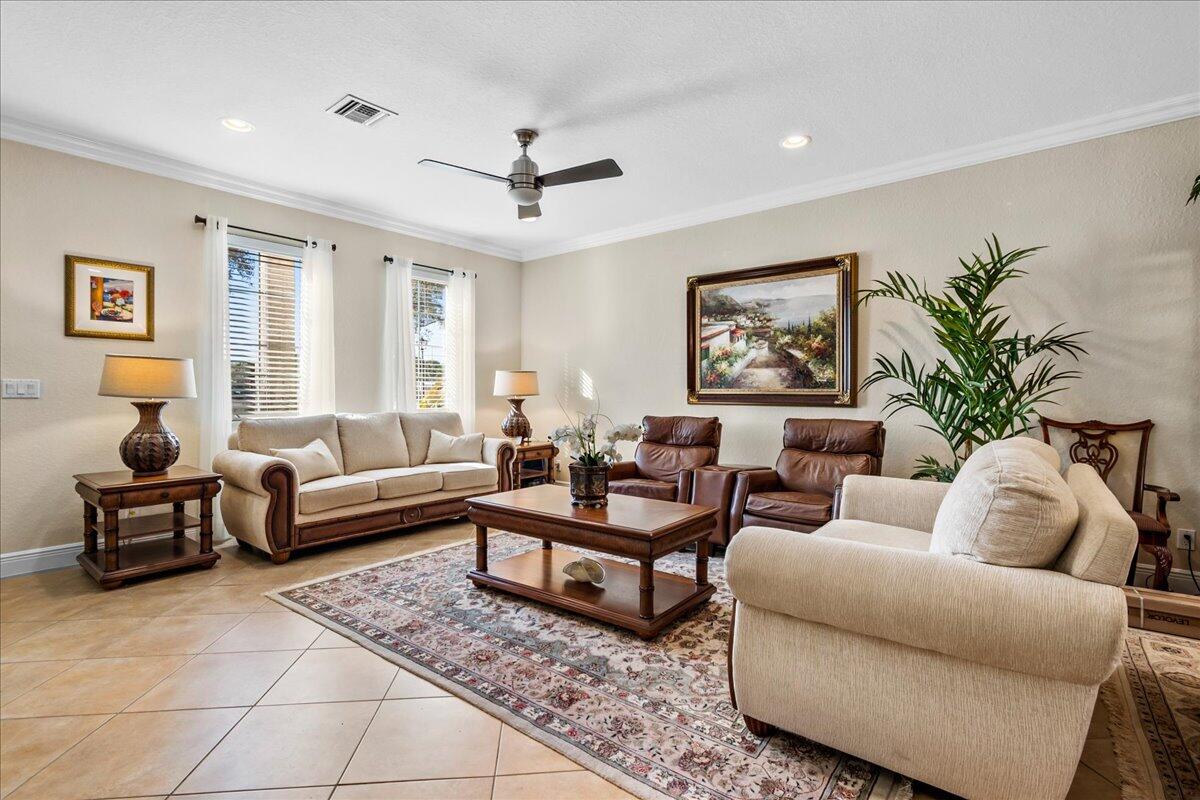 603 Dakota Drive Jupiter, FL 33458 - Photo 3 of 34 a living room with furniture potted plant and a window