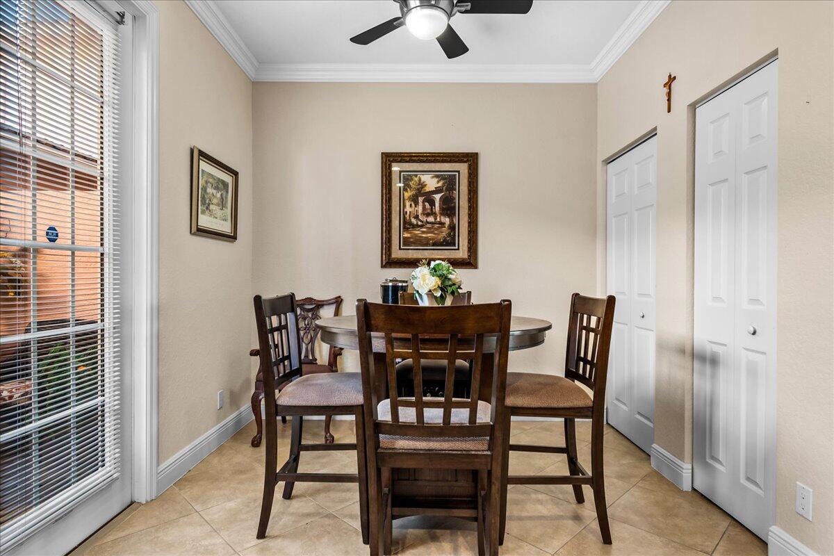 603 Dakota Drive Jupiter, FL 33458 - Photo 5 of 34 a view of a dining room with furniture and wooden floor