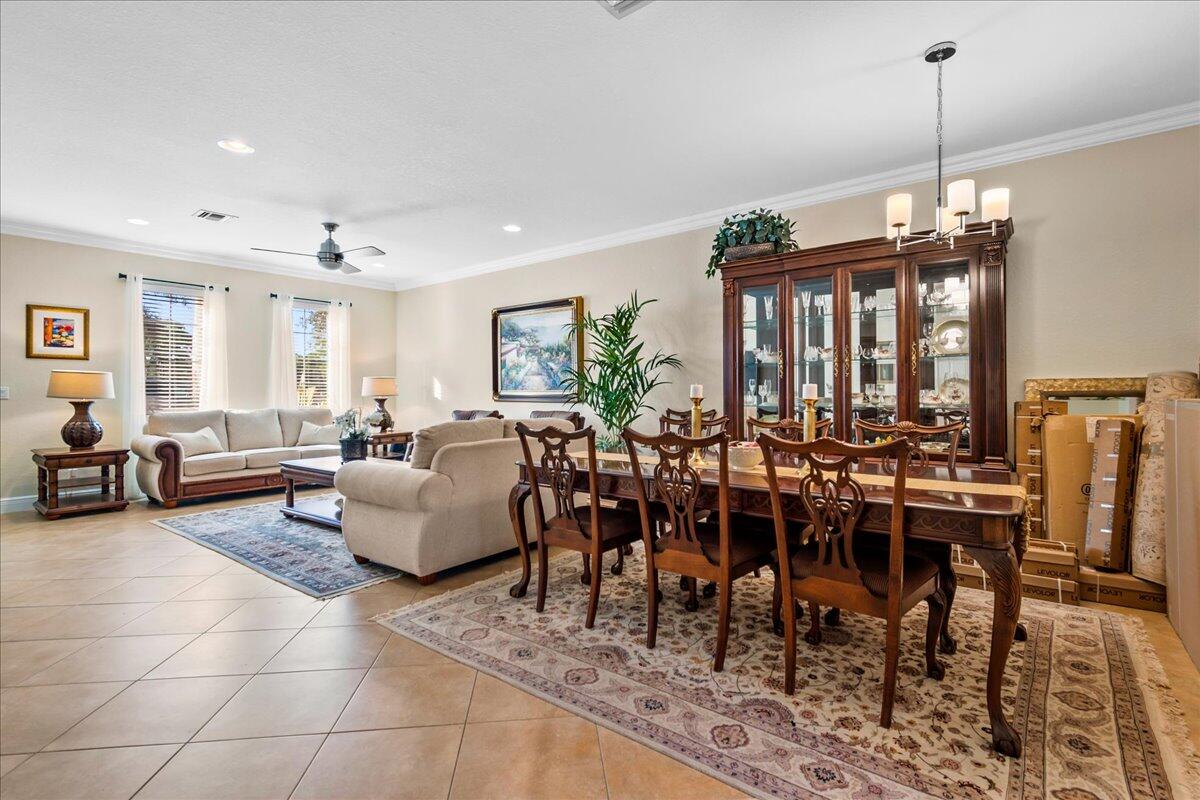 603 Dakota Drive Jupiter, FL 33458 - Photo 8 of 34 a living room with lots of furniture and a chandelier