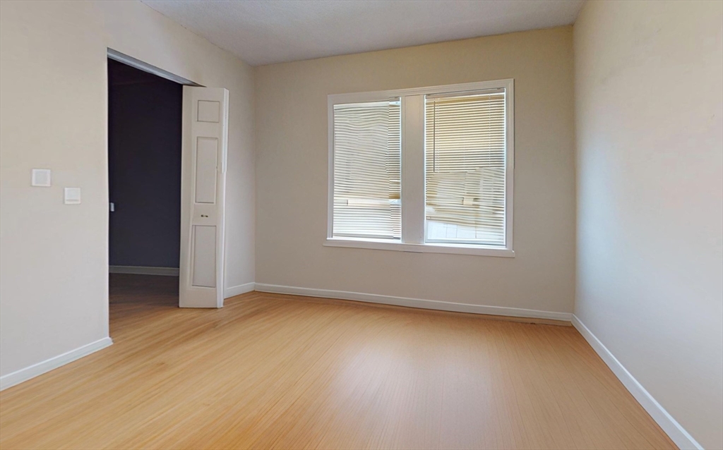 5 Edgar Terrace, Unit 1 Somerville, MA 02145 - Photo 5 of 10 an empty room with a window