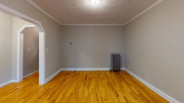 a view of a room with wooden floor
