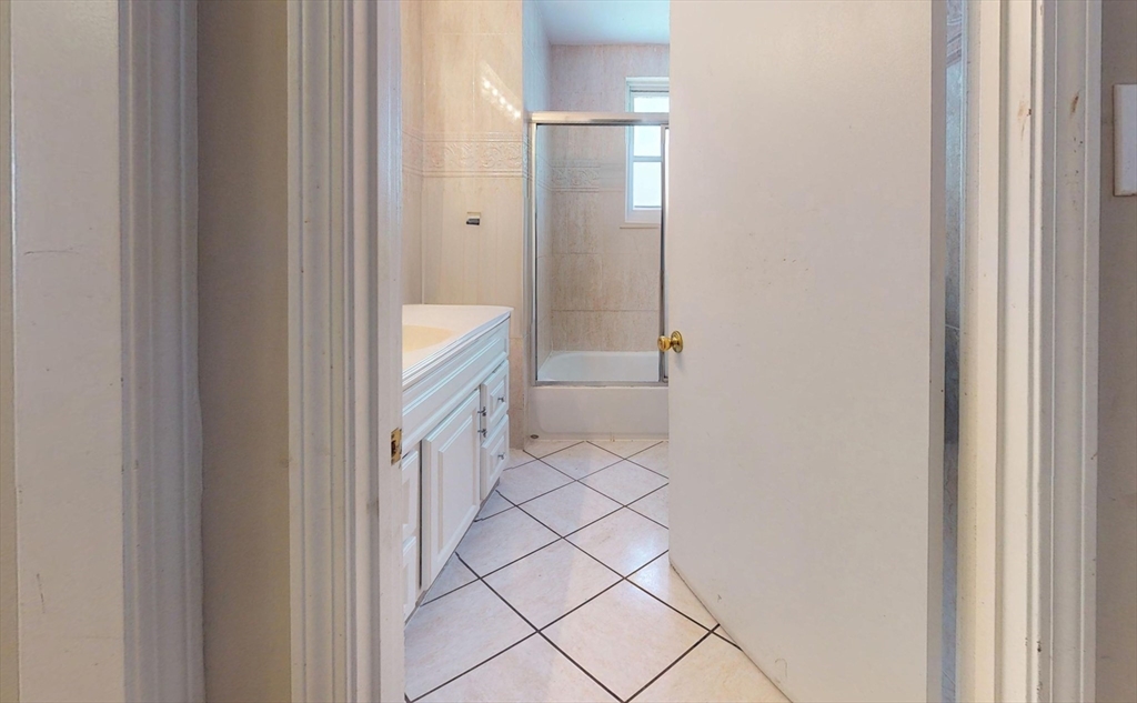 5 Edgar Terrace, Unit 1 Somerville, MA 02145 - Photo 9 of 10 a bathroom with a sink and a mirror