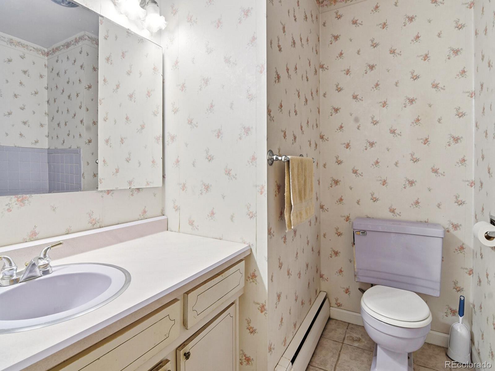 2830 Kerr Gulch Road Evergreen, CO 80439 - Photo 24 of 48 a bathroom with a granite countertop sink toilet and shower