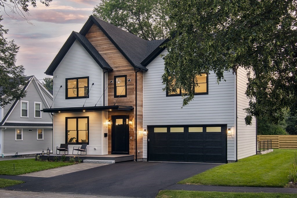 a front view of a house with a yard and garage