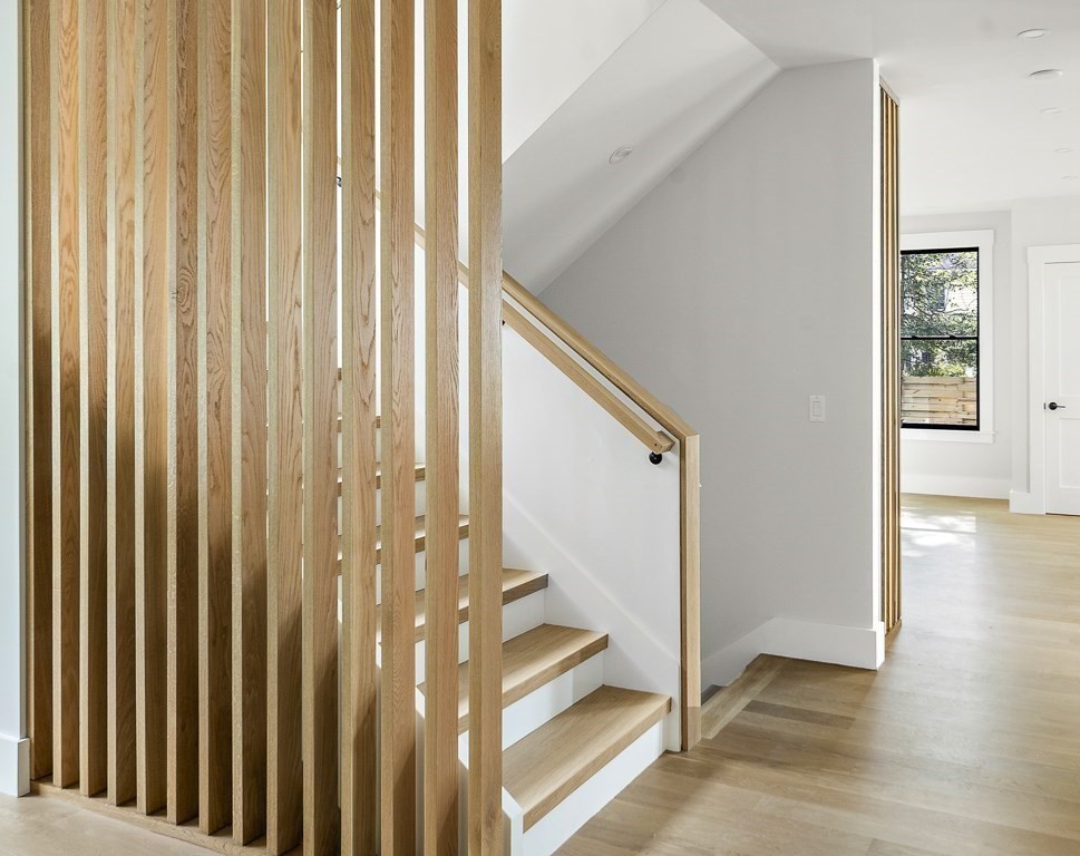 27 Coolidge Avenue Needham, MA 02492 - Photo 15 of 39 a view of a hallway with wooden floor and staircase