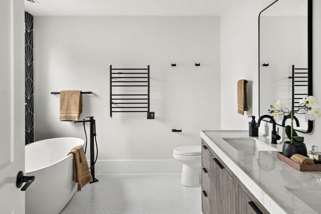 27 Coolidge Avenue Needham, MA 02492 - Photo 20 of 39 a bathroom with a sink a toilet and mirror