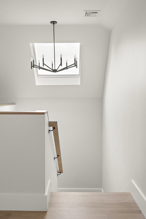 27 Coolidge Avenue Needham, MA 02492 - Photo 26 of 39 a view of a hallway with a refrigerator