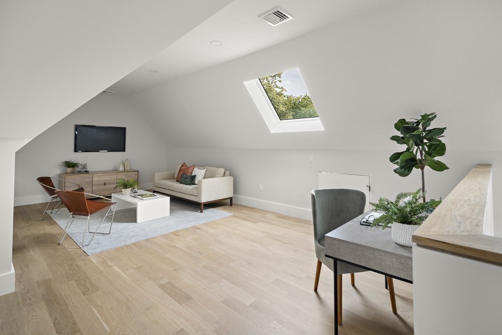 27 Coolidge Avenue Needham, MA 02492 - Photo 27 of 39 a living room with furniture and a potted plant