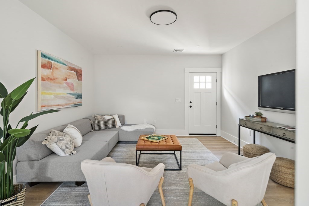 27 Coolidge Avenue Needham, MA 02492 - Photo 28 of 39 a living room with furniture and a flat screen tv