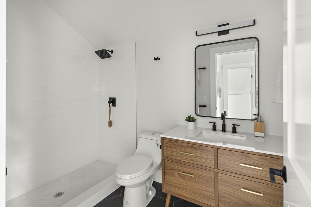 27 Coolidge Avenue Needham, MA 02492 - Photo 29 of 39 a bathroom with a sink a toilet and shower