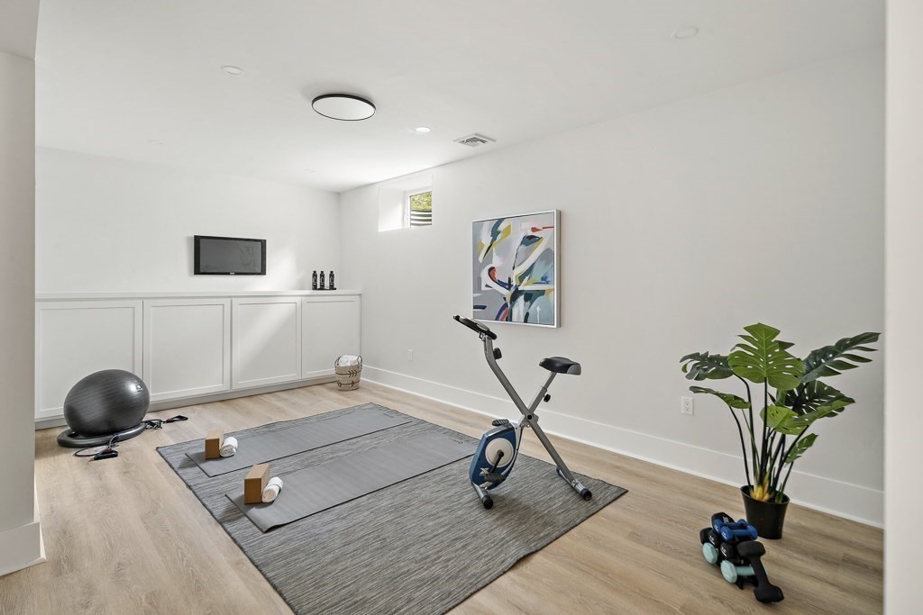 27 Coolidge Avenue Needham, MA 02492 - Photo 33 of 39 a view of a workspace with furniture and a potted plant