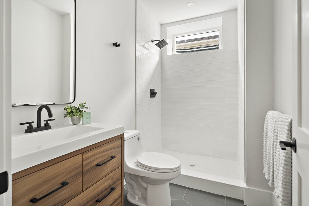 27 Coolidge Avenue Needham, MA 02492 - Photo 35 of 39 a bathroom with a sink a toilet and shower