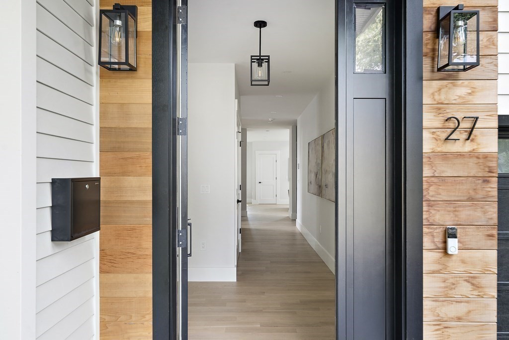 27 Coolidge Avenue Needham, MA 02492 - Photo 4 of 39 a view of a hallway with wooden floor and staircase