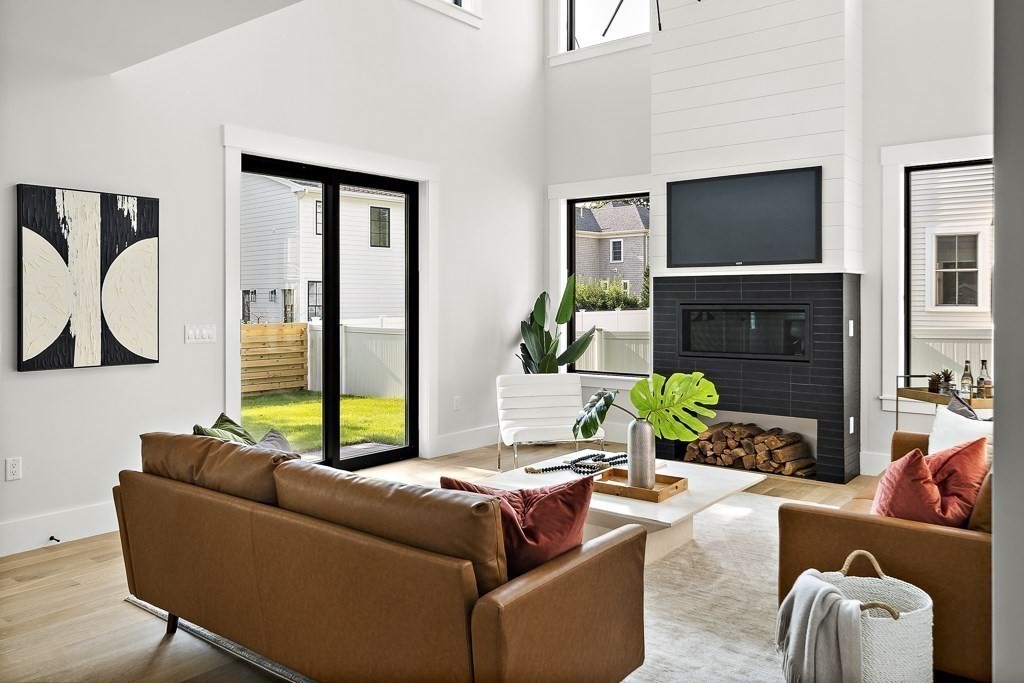 27 Coolidge Avenue Needham, MA 02492 - Photo 6 of 39 a living room with furniture a flat screen tv and a fireplace