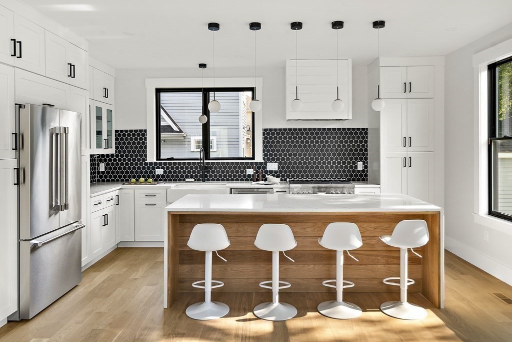 27 Coolidge Avenue Needham, MA 02492 - Photo 9 of 39 a kitchen with granite countertop a sink stainless steel appliances and cabinets
