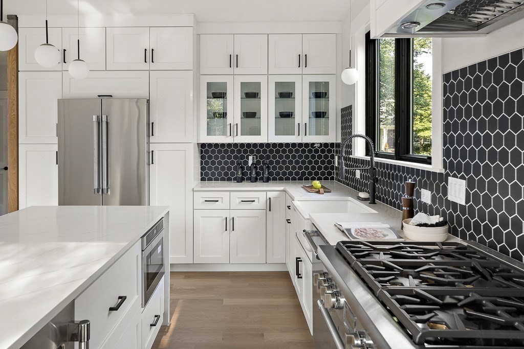 27 Coolidge Avenue Needham, MA 02492 - Photo 10 of 39 a kitchen with a stove and a refrigerator