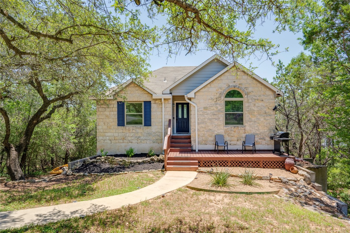 a view of a house with a yard and large tree