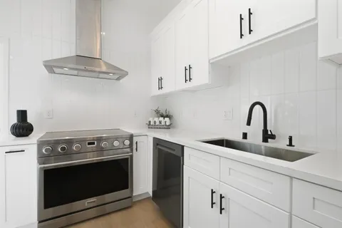 a kitchen with a stove and a sink