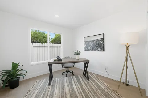 a workspace with furniture and a potted plant