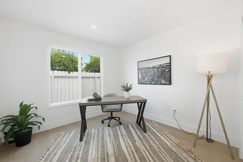 a workspace with furniture and a potted plant