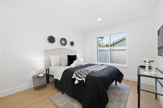 a bedroom with a bed and painting on the wall