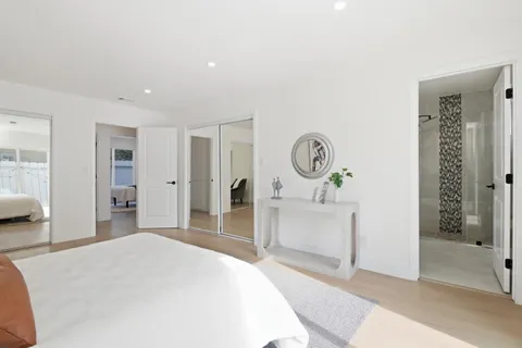 a bedroom with a bed and a mirror