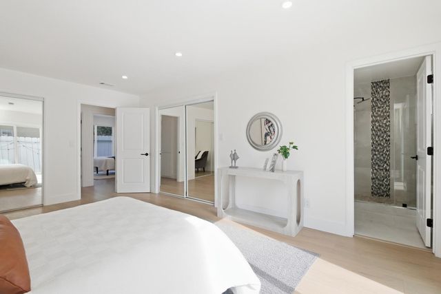 a bedroom with a bed and a mirror