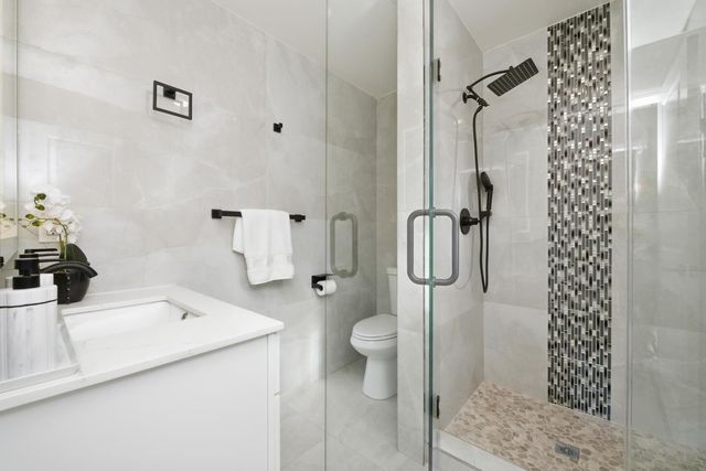 a bathroom with a sink toilet and shower