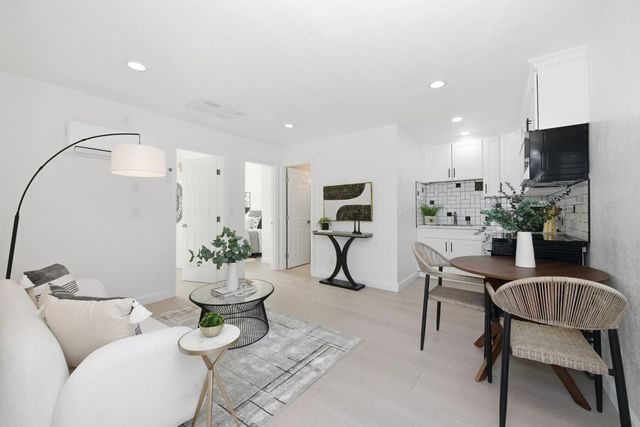 a living room with furniture and a potted plant
