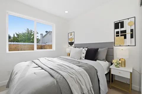 a bedroom with bed and a window