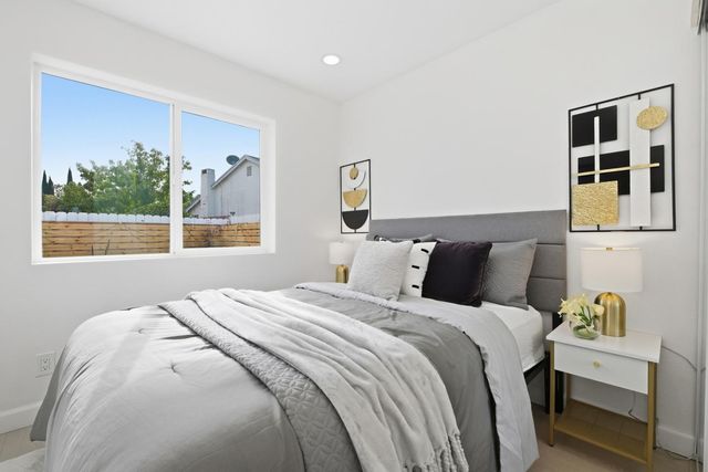 a bedroom with bed and a window