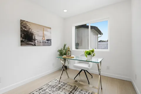 a workspace room with furniture and wooden floor