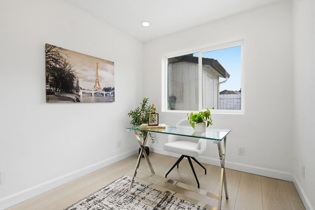 a workspace room with furniture and wooden floor
