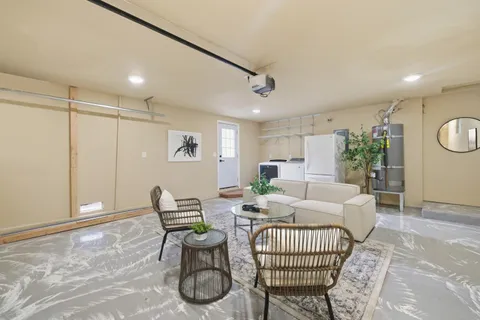 a living room with furniture a rug and a window