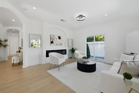 a living room with furniture a window and a potted plant