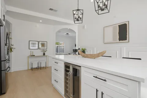 a spacious bathroom with a double vanity sink a mirror and a bathtub