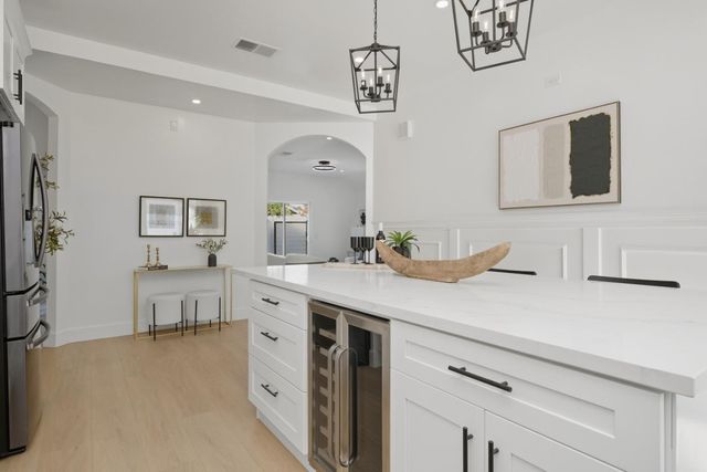 a spacious bathroom with a double vanity sink a mirror and a bathtub