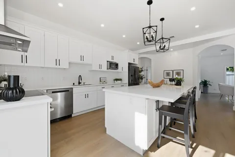 a kitchen that has a lot of cabinets in it and appliances