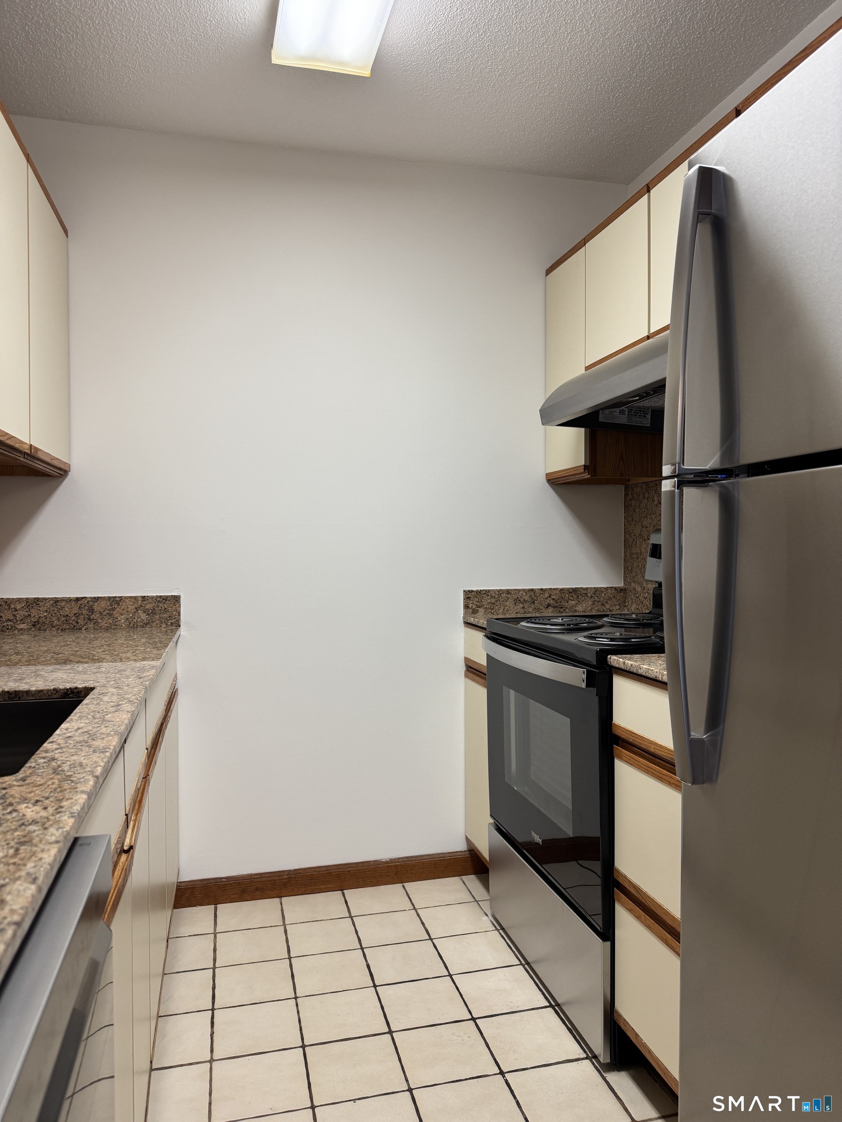 1022 Main Street, Unit 7 Branford, CT 06405 - Photo 6 of 10 a kitchen with a stove top oven and cabinets