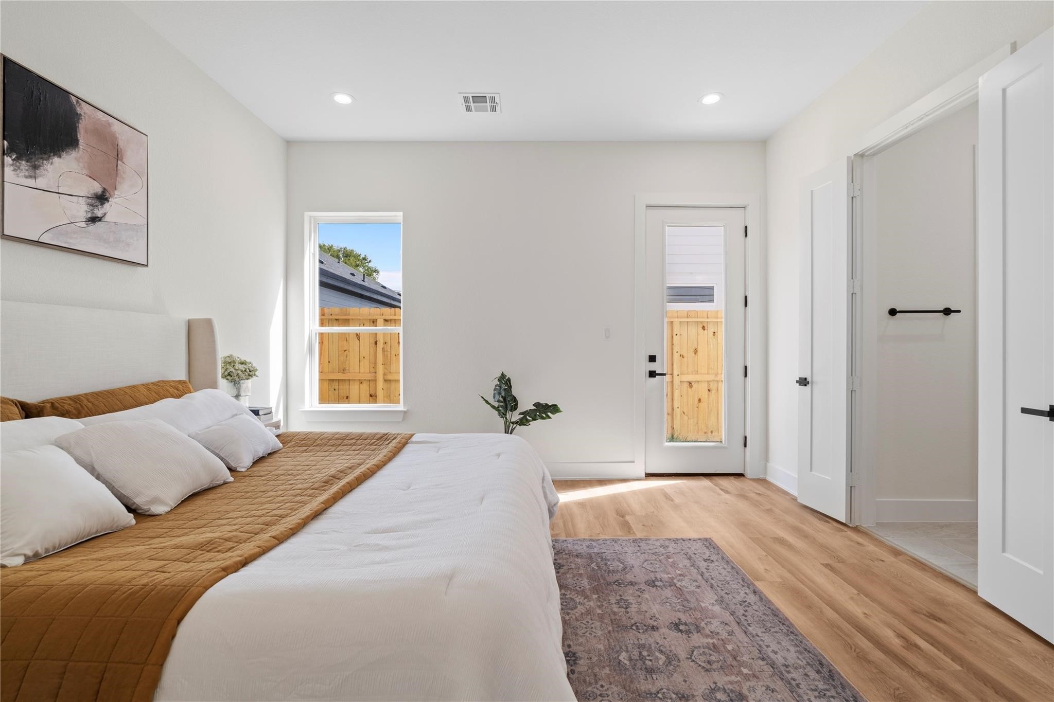 6532 Weston Street, Unit A Houston, TX 77021 - Photo 15 of 29 a bedroom with a large bed and wooden floor